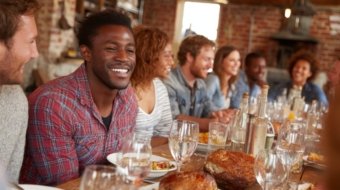 vecteezy_a-group-of-people-sitting-at-a-table-with-food_69187488