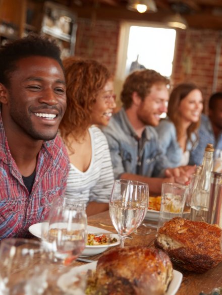 vecteezy_a-group-of-people-sitting-at-a-table-with-food_69187488